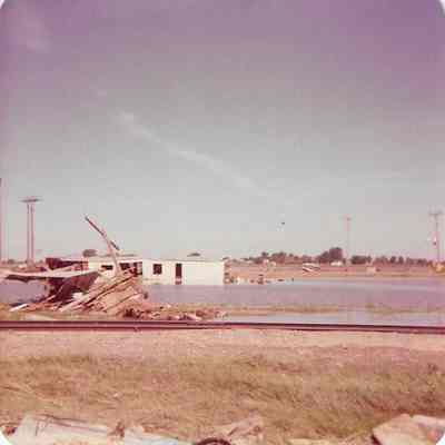 White building with flood debris outfront