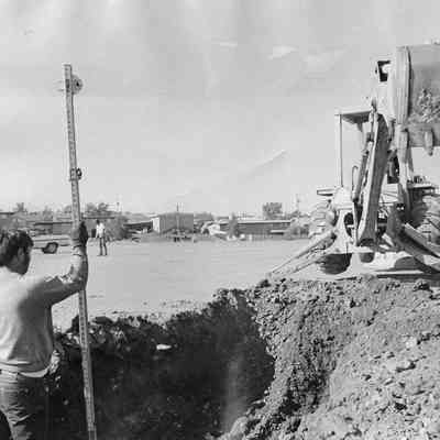 Men Digging Hole Using Heavy Equipment