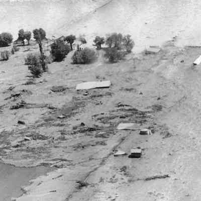 Flood Waters with Debris Through Farmer's Field