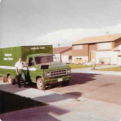 Man Standing outside of American Linen Supply Green Truck
