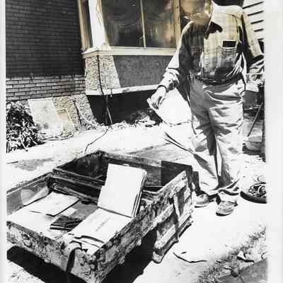 Man Going Through Flood Damaged Box