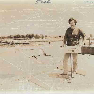 Man Standing Next to Mailbox