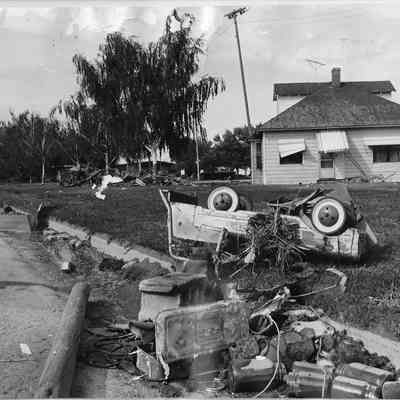 Upside Down Car in Lawn Flood Debris