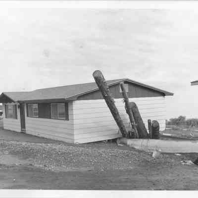 Home with logs sticking out basement