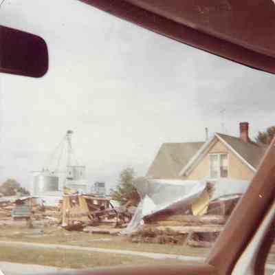 Red Brick Home with Flood Debris in Front Yard