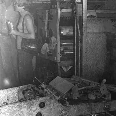 Man & Woman standing in Flood Damaged Newspaper Printing Room