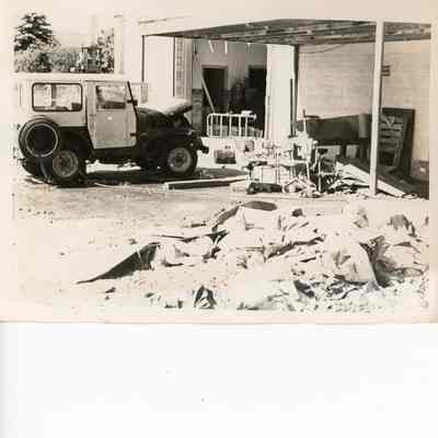 Flood damaged building and Jeep