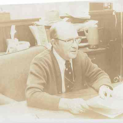 Man In Suit Sitting at Desk