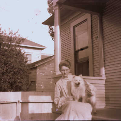 Lady with dog on porch