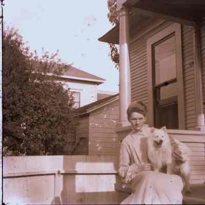 Lady with dog on porch