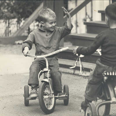 2 boys on tricycles