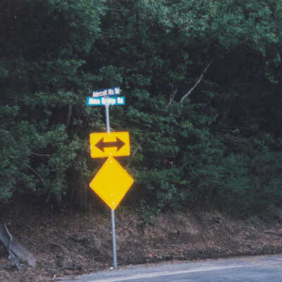 Route of the SPC and SP Railroads: Road sign marking the intersection of Alma bridge Road and Aldercroft Heights