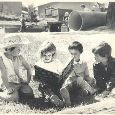 Child in group holding large book