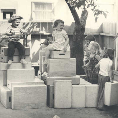 Children playing with stacked boxes