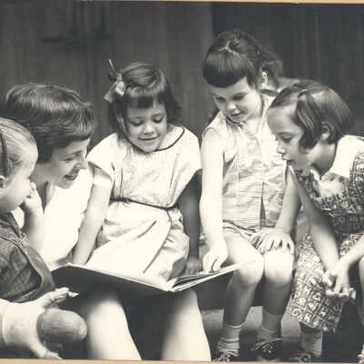 Teacher reading with four girls