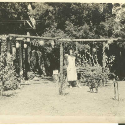 Franks, Lucile Leighton in grape arbor