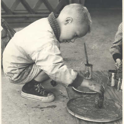 Child creating with paints