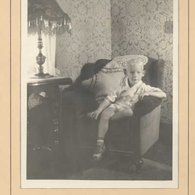 Paul E. Curtis, Jr. on a couch by a window