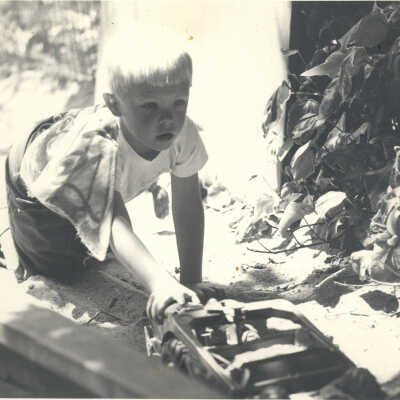 Boy pushing toy truck