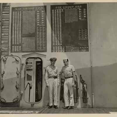 Stephen D. Fitch and Richard L. Montfort in Front of USS Yorktown Score Boards