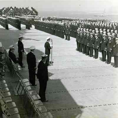 The ship's crew stands on the flight deck for the change of command ceremony.