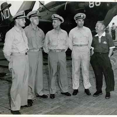 Captain McKechnie talks with other officers on the flight deck.