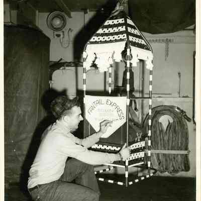 A sailor decorates one of the Yorktown's boson's chairs.