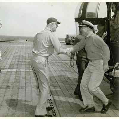 Captain McKechnie shaking hands with an officer coming onboard.