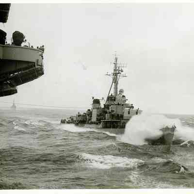 An unidentified destroyer battles harsh seas while attached to The USS Yorktown (CVA-10)