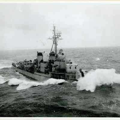 An unidentified destroyer battles harsh seas while attached to The USS Yorktown (CVA-10)