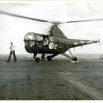 Navy helicopter sitting on the Yorktown's flight deck.