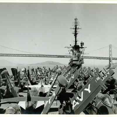 The USS Yorktown (CVA-10) leaving San Frisco with her flightdeck filled with Grumman F9F Cougars, F9F Panthers, and Douglas A-1 Skyraiders.