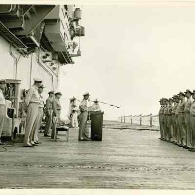 Captain Arnold McKechnie reading his orders to the crew during the change of command ceremony.