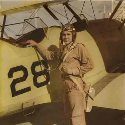 Elisha "Smokey" Stover Standing in Front of a Stearman Biplane