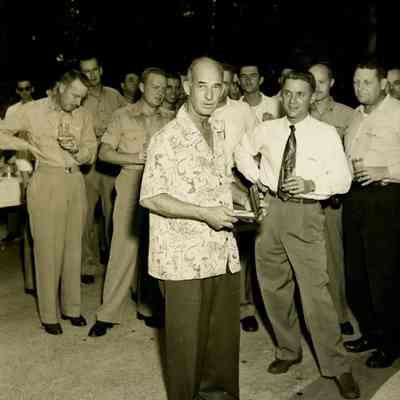 Captain Arnold McKechnie Opening a Gift at His Farewell Party in 1954