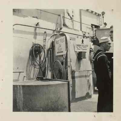 This photograph shows the damage done by a "near miss" as fragmentation damage pierced one of the Laffey's bulkhead doors.