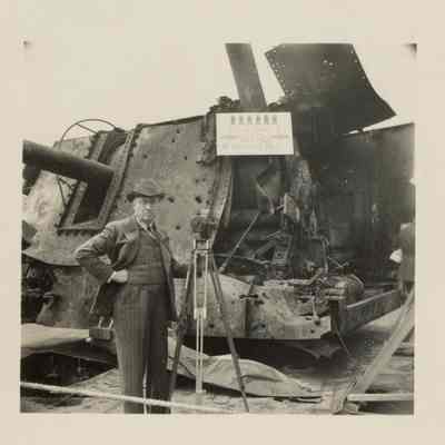 A man with a camera stands in front of gun mount 53.