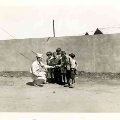 Irven Klug Giving Candy to Children
