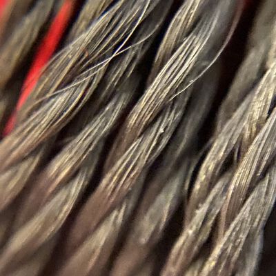 Magnifier image of black tassels, of synthetic material