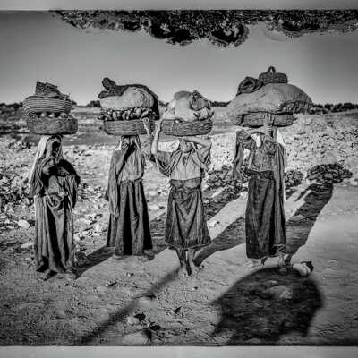 Four Palestinian women on their way to market with baskets on heads