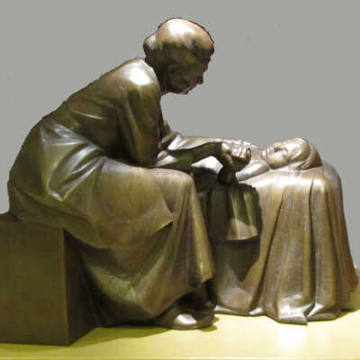 Female Doctor looking over a Sick Child