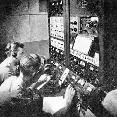 The FCC's "Cruising Room." Operators search for a lost aircraft. Note four SX-28 receivers.: Image: Radio News, Oct 1944