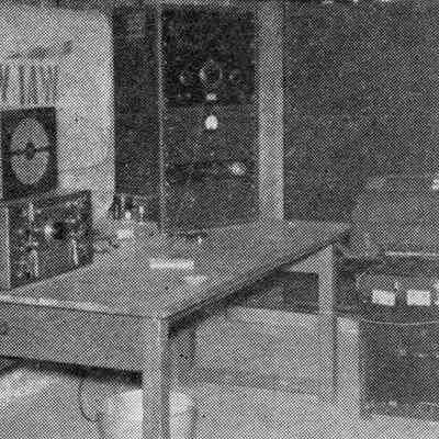 The basement at W1AW. Equipment in use: On desk (from left) National HRO-60 with HRO-60TS speaker. .: Image: CQ magazine, Dec 1956