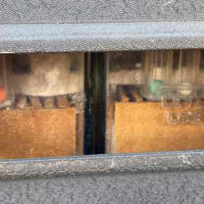 The batteries' state of charge could be observed through this window, and was indicated by the green, white, and red balls which floated–or not–in the electrolyte.: Image: Chuck Penson, WA7ZZE / Collection: westvalleyhamshack.com