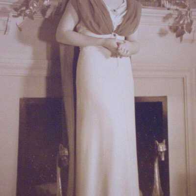 Young woman standing in front of fireplace