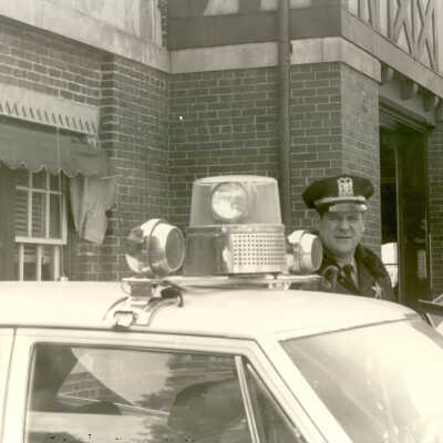 Police officers and car in front of Forest Avenue station