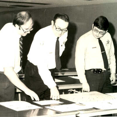 Police officers looking at diagrams