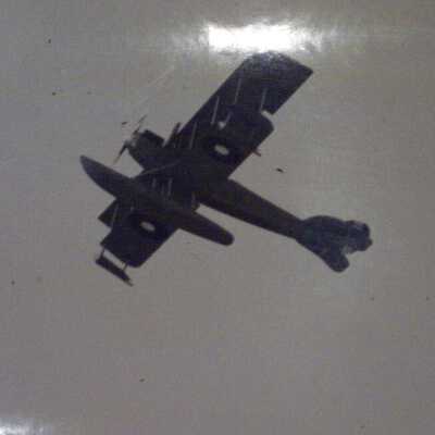 Two aviators and a biplane aloft