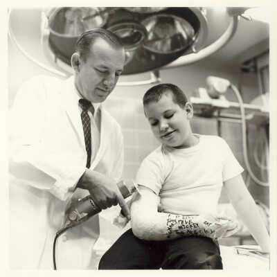 Dr. Apfelbach Prepares to Remove Cast of Patient