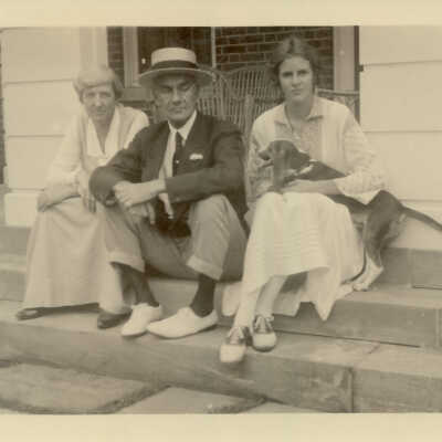 Miss Smart and the McGanns sitting on the steps